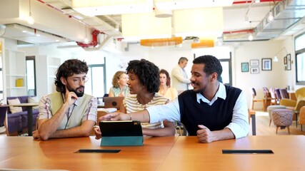 Diverse coworkers collaborating on tablet in modern office - Powered by Adobe
