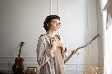 Serene woman rest hands on chest to monitor breath rhythm, quiet reflection and stress relief....
