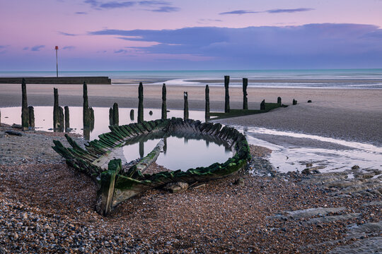 Shipwreck on Broomhill Sands low tide sunset on the east Sussex coast south east England UK