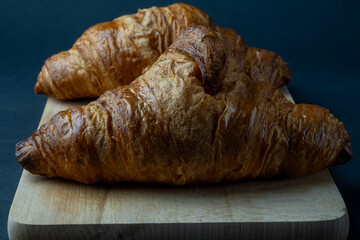 Fresh croissant and black background