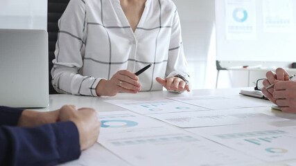 Business team analyzing financial charts and data reports during strategy meeting, hands pointing to documents on table with graphs and diagrams for planning - Powered by Adobe
