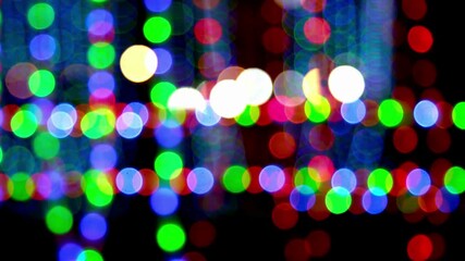 Abstract colorful bokeh background with blinking blue, green and red LED lights forming a festive curtain pattern for holiday and event video overlays - Powered by Adobe