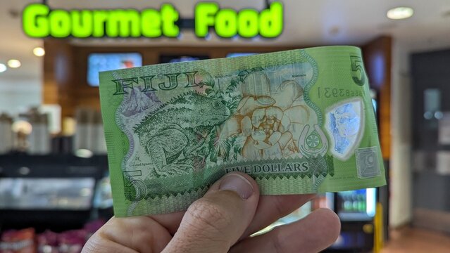 Closeup of Fijian five dollar currency money note in gourmet food cafe in Nadi, Fiji, South Pacific - taken on 19 Nov 2025