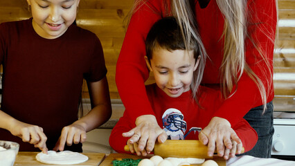 A family is enjoying time together baking in the kitchen for Christmas
