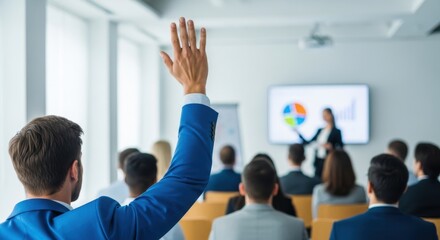 Businessman raising hand to ask question at business presentation