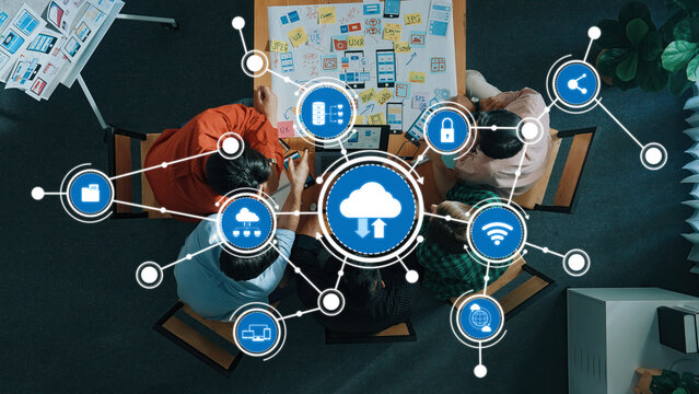 A diverse group of individuals collaborates in an office setting, leveraging cloud computing and digital tools to enhance communication and idea generation. Amity