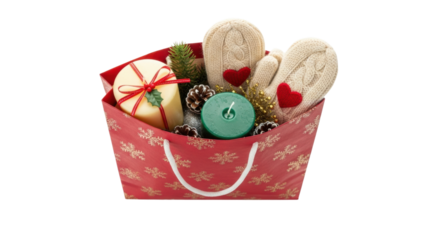 A red holiday gift bag with a snowflake pattern is filled with cozy knitted mittens, festive candles, pinecones, and seasonal decorations for a winter celebration