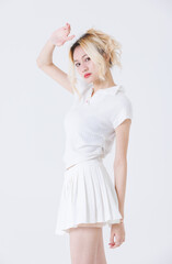 Asian confident attractive beautiful young woman blonde hair tied stand wearing white shirt top mini skirt sport background studio, portrait lifestyle fashion outfit trendy style pose look at camera.