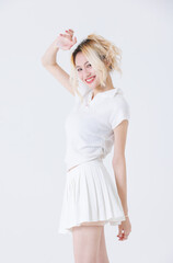 Asian confident attractive beautiful young woman blonde hair tied stand wearing white shirt top mini skirt sport background studio, portrait lifestyle fashion outfit trendy style pose look at camera.