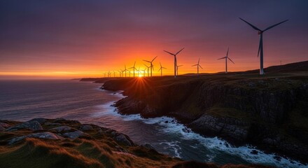A serene sunset over a rocky coastline with wind turbines in the distance, illuminated by the warm hues of the setting sun.