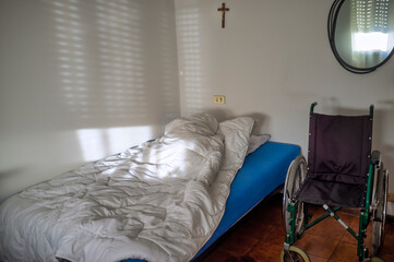 Minimalist Bedroom with Empty Wheelchair and Morning Light