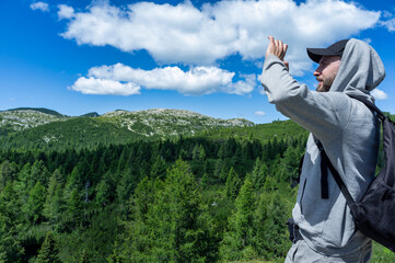 Hiker Enjoying Mountain View on a Sunny Day
