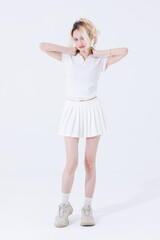 Naklejka premium Asian confident attractive beautiful woman blonde hair tied stand wear white shirt top mini skirt sport on background studio portrait fashion street outfit trendy style pose look at camera full length