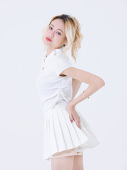 Asian confident attractive beautiful young woman blonde hair tied stand wearing white shirt top mini skirt sport background studio, portrait lifestyle fashion outfit trendy style pose look at camera.