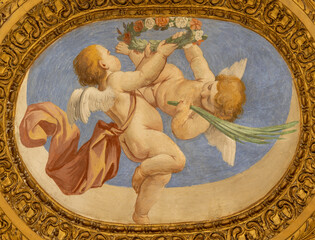 Obraz premium SALERNO, ITALY - OCTOBER 6, 2025: The baroque fresco of angels with the floral wreath in the church Chiesa di San Giorgio by Francesco Solimena (1674‑1675)