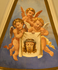 Obraz premium PRAIANO, ITALY - OCTOBER 6, 2025: The fresco of angels with the instruments of crucifixion (The Veil of Veronica) in the side cupola of church Chiesa di san Gennaro by unknown artist of 20. cent. 