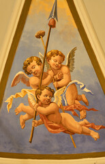 Obraz premium PRAIANO, ITALY - OCTOBER 6, 2025: The fresco of angels with the instruments of crucifixion (spear, sponge) in the side cupola of church Chiesa di san Gennaro by unknown artist of 20. cent. 