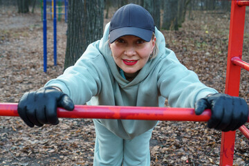 Woman exercising outdoors in autumn time.