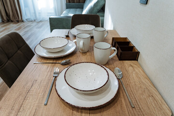 rustic table with warm lighting, homey living room with inviting table and soft illumination, comfortable family setting featuring natural wooden dining area illuminated warmly by sunlight