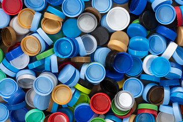 Close up plastic bottles caps for recycling to conserve the environment, recycling, reuse, garbage disposal, save the world concept.