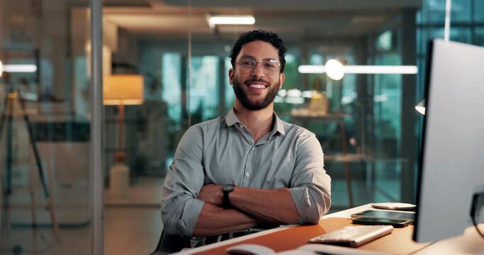 Face, night and happy man with arms crossed, computer and financial advisor with pride. Evening, person and investor in office, pc and smile with confidence, career ambition and business growth