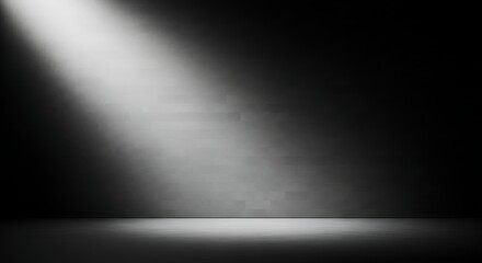 Dark room with a single spotlight illuminating a brick wall beam