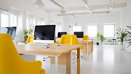 bright modern office with yellow chairs, open workspace filled with natural light, contemporary design with plants and computers, national clean your desk day