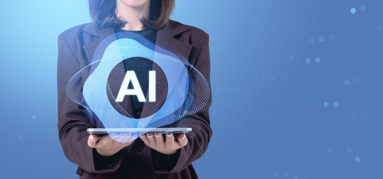 Businesswoman holding tablet with glowing AI hologram over blue tech background, symbolizing digital innovation and future intelligence concept.