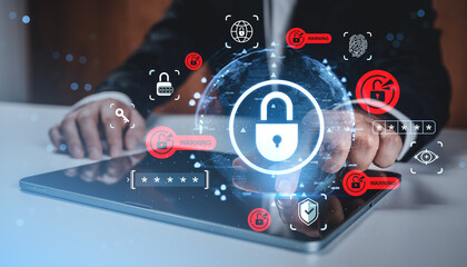 Cybersecurity concept with digital padlock and hacking warning icons overlay on businessman using tablet background in office environment.