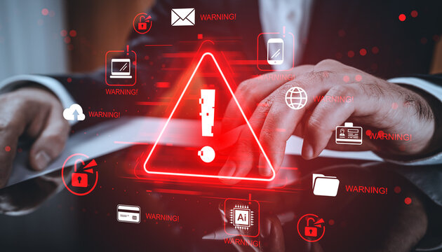 Cybersecurity warning concept with hands using tablet and red glowing alert symbols on digital background of hacking and data breach threats.