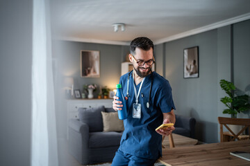 Healthcare worker relaxing at home checking mobile phone