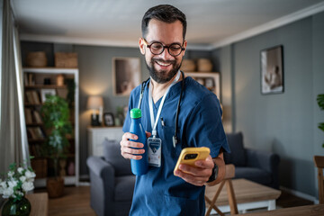 Male healthcare worker relaxing at home checking phone