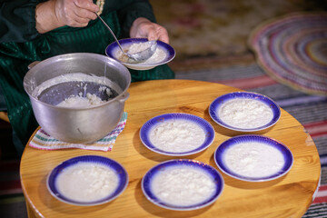 Countryside Cooking Scene. Elderly Woman Preparing Classic Homemade Meals Outside. Grandma Making Traditional Family Dishes. Rural Heritage Cuisine in Moldova.
