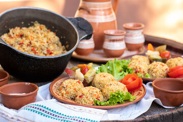 Countryside Cooking Scene. Elderly Woman Preparing Classic Homemade Meals Outside. Grandma Making Traditional Family Dishes. Rural Heritage Cuisine in Moldova.