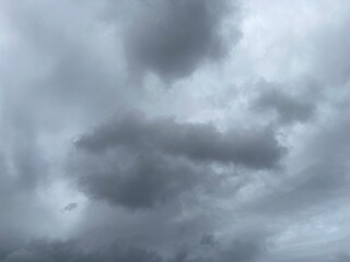 Overcast sky filled with dark, dramatic storm clouds. The image captures the moodiness and power of nature