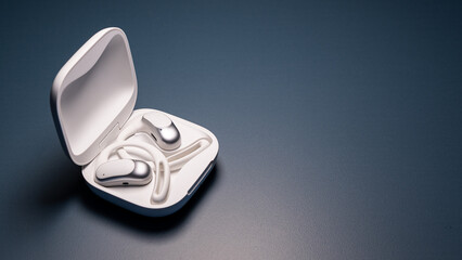 Modern, silver-finished wireless ear-hook headphones nestled in their open white charging case on a dark background.