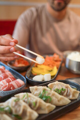 Close-up of danmuji, pickled radish, banchan, and other Korean appetizers in a restaurant. Fermented food, traditional Asian meals.