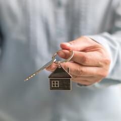 House key in landlord, real estate sale person or home Insurance broker agent hand giving to...