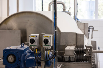 A large industrial rotary drum vacuum filter in a potato starch factory. Wet starch pulp is fed onto the drum, and a doctor blade scrapes off the finished, dried white starch sheet.