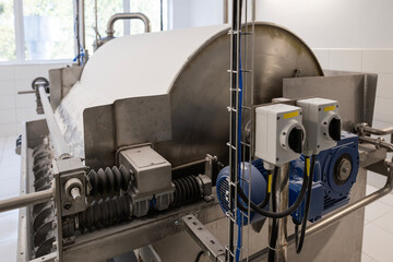 A large industrial rotary drum vacuum filter in a potato starch factory. Wet starch pulp is fed...