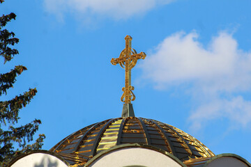 photo taken on June 3, 2025 on Jahorina, showing the golden dome and cross of the Serbian Orthodox Church of St. Basil the Great under a bright blue sky.