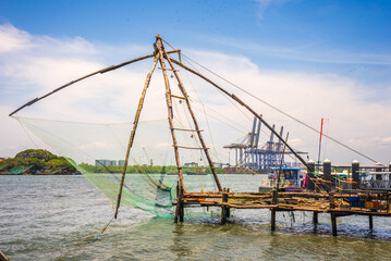 Fort kochi area with restaurants water metro Chinese fishing nets and cargo port activities