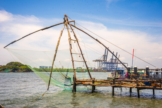 Fort kochi area with restaurants water metro Chinese fishing nets and cargo port activities