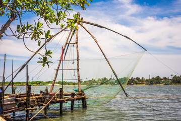 Fort kochi area with restaurants water metro Chinese fishing nets and cargo port activities