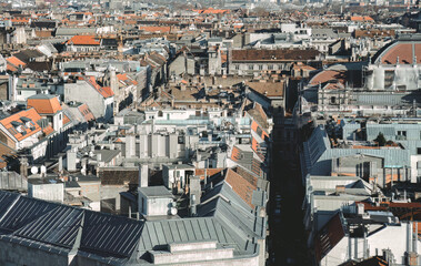 Narrow street disappearing between buildings in Budapest cityscape, Hungary