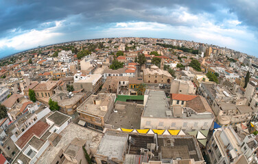 Nicosia city skyline panorama showing traditional houses and buildings under a cloudy sky