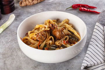 Asian cuisine udon with chicken and vegetables