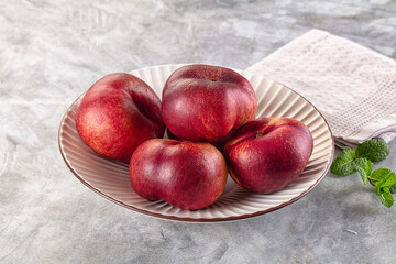 Ripe sweet juicy flat nectarines heap