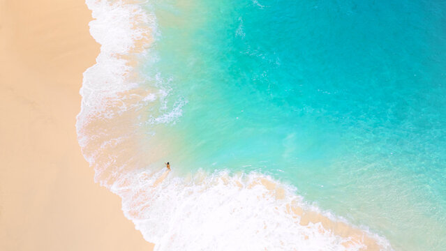Woman Standing In Turquoise Shoreline On Bright Sandy Tropical Beach - Powered by Adobe