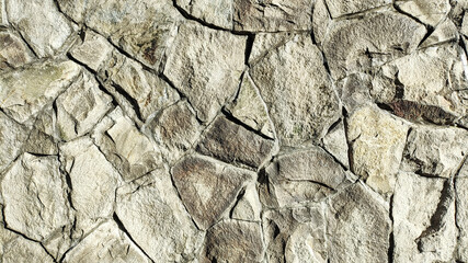 Fototapeta premium Natural stone wall texture, rough gray broken stone